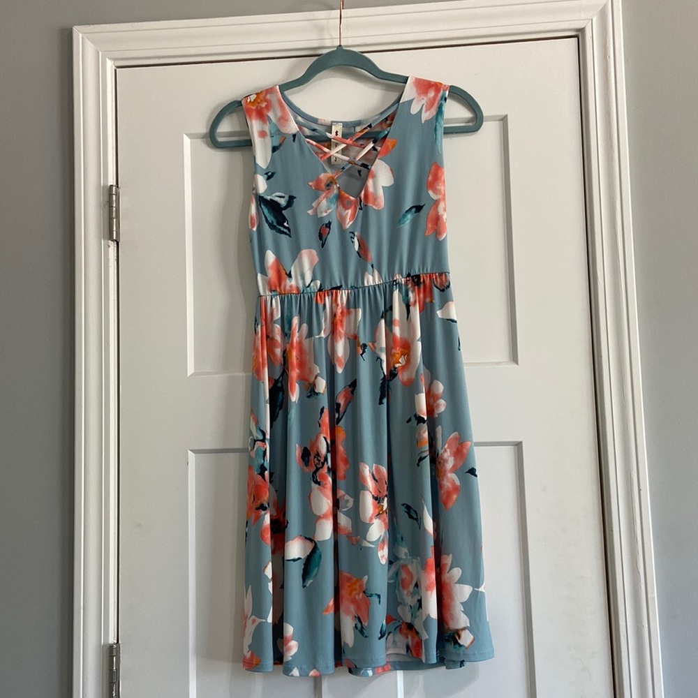 Blue floral sleeveless dress with crisscross neckline